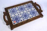 Full view of the rectangular tray showing six blue and white patterned ceramic tiles and carved wooden frame with handles.