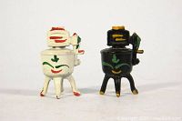 Front view of the pair of wash tub shaped salt and pepper shakers, showing their painted details and legs