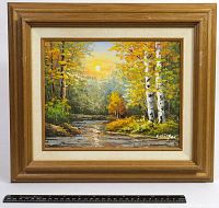 Frontal view of oil painting showing wooded pond scene with autumn trees and sun, framed in wood frame.