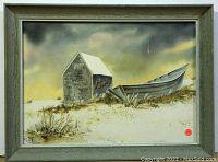 Framed watercolor painting showing a small shed and boat on a beach under cloudy skies.