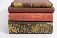Stack of four books showing spine details: Oliver Twist, A Christmas Carol, Hans Brinker, Waverly Novels Vol 7.