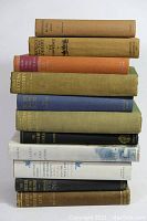 Stack of 11 vintage books showing various titles and colors, some dust jackets visible