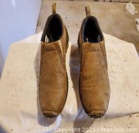 Overhead view of Merrell Jungle Mocs showing the tan suede finish and shape of the shoes.