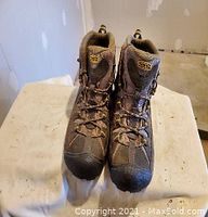 Front view of brown Keen men's hiking boots size 11, showing laces and overall condition.
