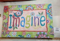 Canvas print with word Imagine and floral border