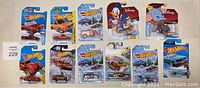 Photo showing all 12 unopened Hot Wheels toy cars in packaging, including Disney-themed cars and various models
