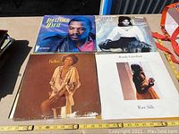 Top view of four vinyl record album covers showing artists Al Jarreau, Gladys Knight and the Pips, Kellee Patterson, and Randy Crawford.