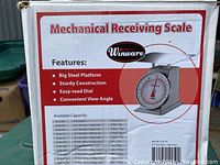 Close-up of the scale packaging front showing features and a photo of the scale.