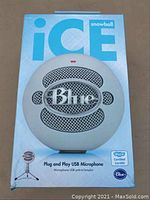 Front of the box showing the Blue logo on the microphone grill and product branding as 'Snowball Ice'. The box is white and blue with minor wear.