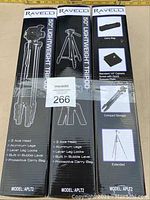Boxes of three new Ravelli 50-inch lightweight tripods with detailed product images and specifications
