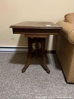 Front view of rectangular occasional table showing pedestal base and carved bracket feet