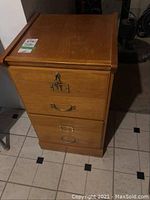 Front view of the wood filing cabinet showing two drawers and lock on the top drawer