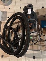 Top view of Ridgid WD40501 shop vacuum with coiled hose and storage frame attached, showing orange power button and branding.