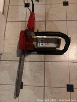 Top view of the red Sears Craftsman electric chainsaw with the chain and guide bar visible.