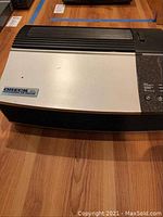 Full view of Oreck XL Professional Air Purifier showing casing and vent grills on top surface.