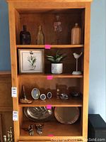 Full lot arranged on wooden shelving unit
