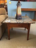 Side table viewed from front showing granite top and drawer beneath