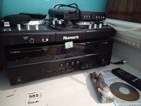 Receiver front view with cables, remote and disc laid out