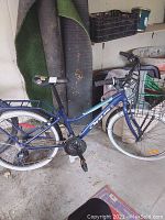 Full left-side view of bike showing frame, Opus branding, front basket, rear rack, fenders and tires