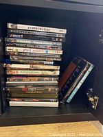Photo of DVDs stacked in a shelf including titles like Nymphomaniac, Fight Club, iPod Season 1, Adaptation, Wall Street, and others