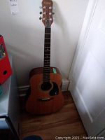 Front view of Epiphone acoustic guitar showing body and fretboard