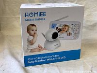 Box of HOMIEE BM1003 baby monitor showing front with baby photo and features.