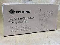 Fit King branded cardboard box with printed info showing the product is a Leg and Foot Circulation Therapy System, model FT-012A, with 3 massage modes and selectable air pressure intensities.