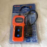 Front view of the Car-Code CAN OBD2 Code Reader Memoscanner U480 device inside display packaging showing the orange and black device with digital screen and two blue buttons, connected to OBD2 cable.