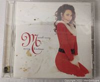Close-up of Mariah Carey's Merry Christmas CD album showing condition of jewel case and album cover.