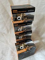 Five boxes of CSB19 Outdoor Bark Control devices stacked showing front and side packaging with product images and branding.