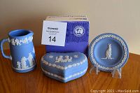 Photo showing the set including the blue jasperware pitcher, heart-shaped trinket box with Royal Wedding 1981 relief, and the miniature plate featuring a kangaroo in white relief.