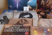 Photo shows 12 vinyl LP records including multiple Barbra Streisand albums, partially stacked and spread out for view.