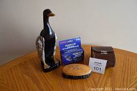 Overview of all items in the lot: decorative duck brush, leather pouch, new cleaning sponge in tin, and two shoe shine brushes on wooden table.