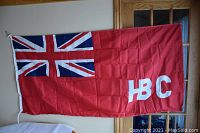 Full view of Hudson Bay Company red ensign nylon flag showing its colors and 'HBC' lettering.