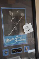 Framed program in black frame with reflective glass, showing full assembly