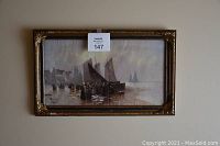 Full view of the framed print showing the coastal fishing scene under subdued lighting on a wall.