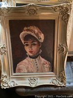 Framed portrait painting of a woman in Victorian-style hat signed A. Dixon in distressed ornate cream frame.