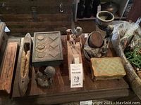 Wooden carved decorative pieces and jewelry boxes arranged on a wooden table.