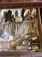 Drawer view showing mixed sterling silver flatware pieces