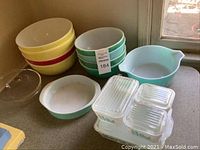 Overall lot: mixing bowls and refrigerator dishes arranged on table