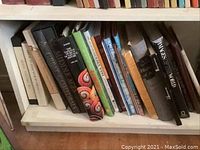 Shelf with a variety of large art history books including The Illustrated Book of Middle Ages, The Pictures That Moved the World, among others.
