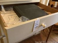 Opened drawer containing a navy "MINT SHEET ALBUM" and multiple sealed plastic sleeves with loose stamp sheets.