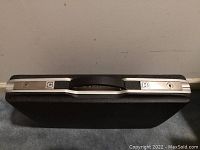 Top view of closed attaché style case showing combination lock and missing keys.