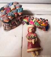 Photo of colorful handmade miniature dolls from Chile Andes with detailed traditional clothing and fabrics