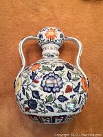 Top view of flower vase showing floral pattern and vase handles