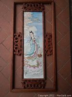 Full view of entire porcelain panel in wooden frame laid on tile floor