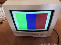 Front view of Azuma CRT monitor powered on displaying color bars screen test.