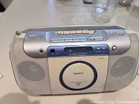 Front view of Sony portable audio system showing speakers, cassette deck, and CD player.