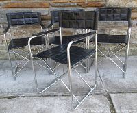 Four chairs grouped showing overall style, upholstery and frame finish