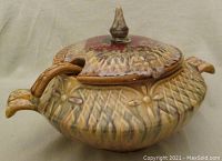 Front and side view of the vintage ceramic soup tureen with lid and ladle, showing textured diamond and flower design and two side handles.